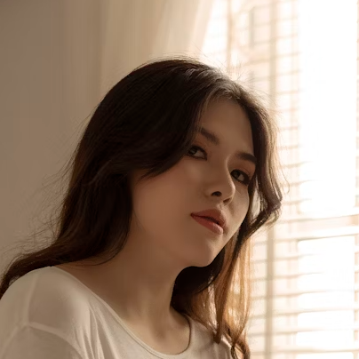 girl in a dirty shirt by the window